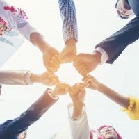 Happy Diversity Teams multiethnic Partners standing with hands together in modern city. Panorama Teamwork group of multi racial confident happiness people joining trust teams partners outdoor